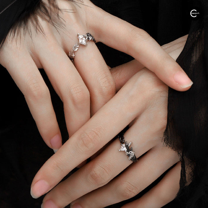 A Part Of Me sterling silver ring with dove and crow motifs worn on two hands