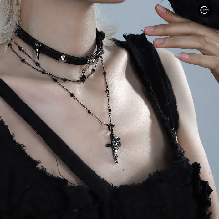 A Part Of Me Raven Series black choker necklace with layered chains and cross pendant worn around the neck