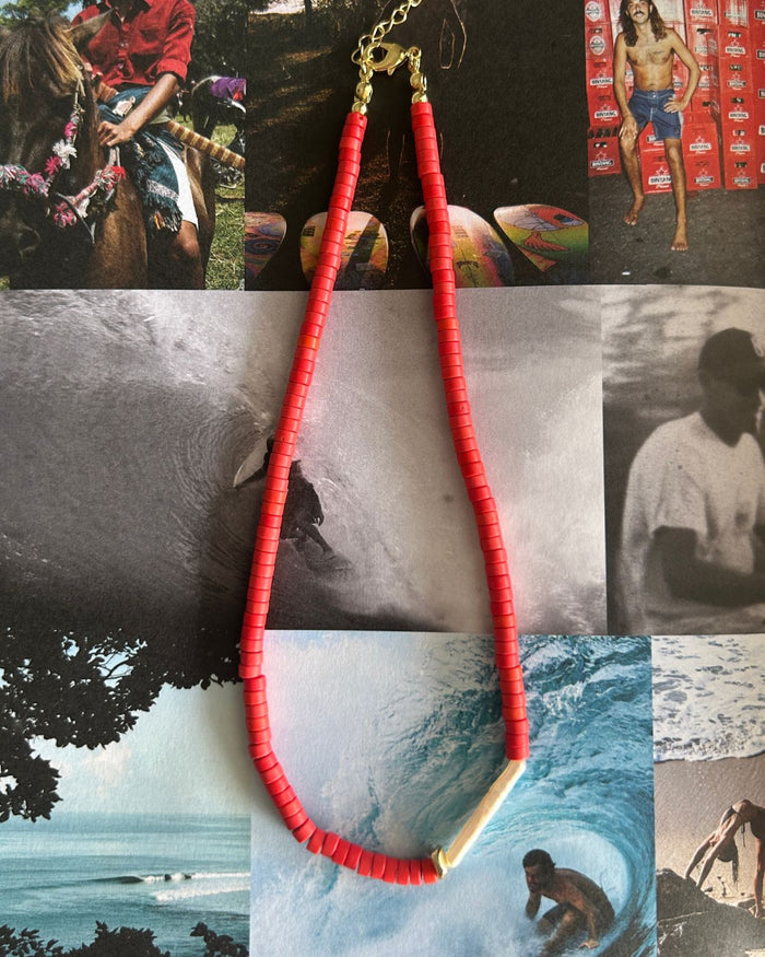 Red bead necklace is beautifully displayed on a lifestyle magazine page