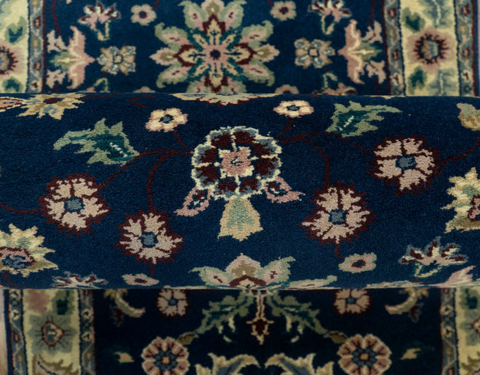 Traditional wool area rug with navy blue floral medallion and beige ornamental pattern