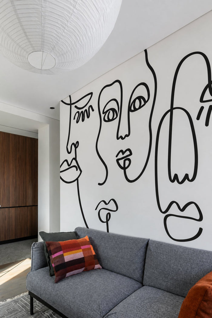 Bold Black Abstract Line Faces mural in a living room