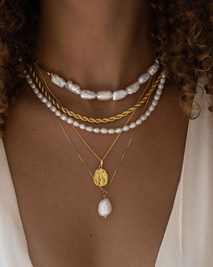 half pearl half choker necklace, twisted chain, dainty pearl necklace, gold crested coin necklace, and large baroque pearl necklace