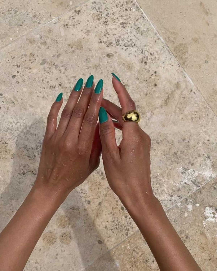 hands featuring a gold thick ring