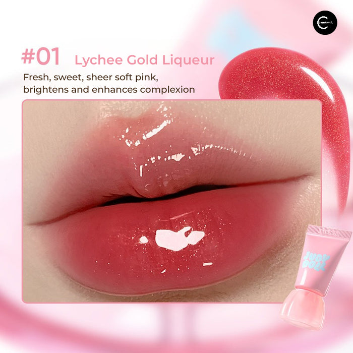 Judydoll Jelly Lip Gloss in #01 Lychee Gold Liqueur, shown on lips with pink gloss tube