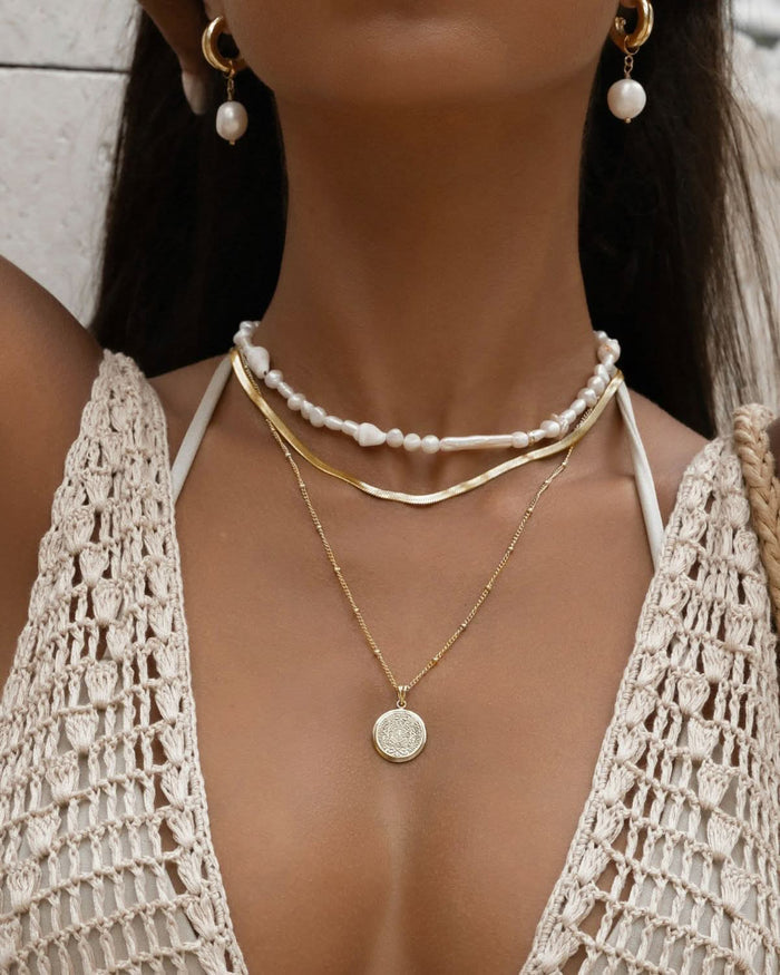 close up on layered pearl necklace