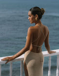 gold jewelry set worn with beige beach dress
