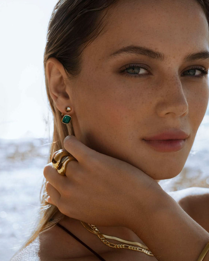 malachite barbell earrings styled with gold jewelry