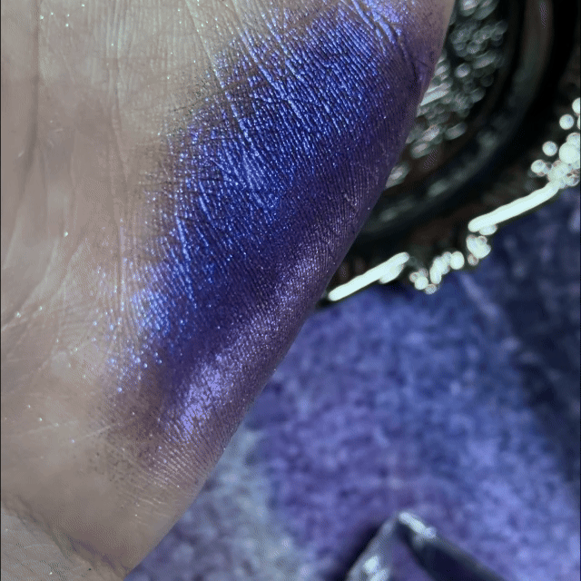 NOIRICORN Lapis Shock eyeshadow swatched on skin, showing a shimmery deep blue-violet finish