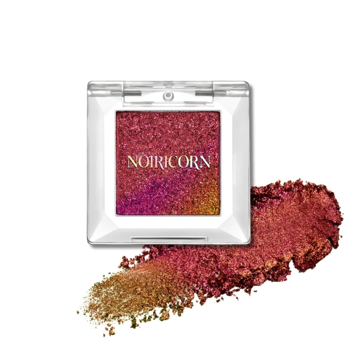 NOIRICORN Solar Flare single eyeshadow pigment in a clear compact with a pink, red and gold swatch