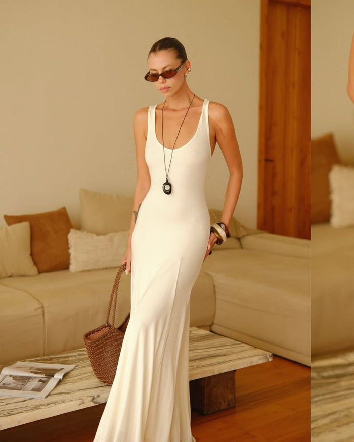 cord necklace with black pendant styled with a dress