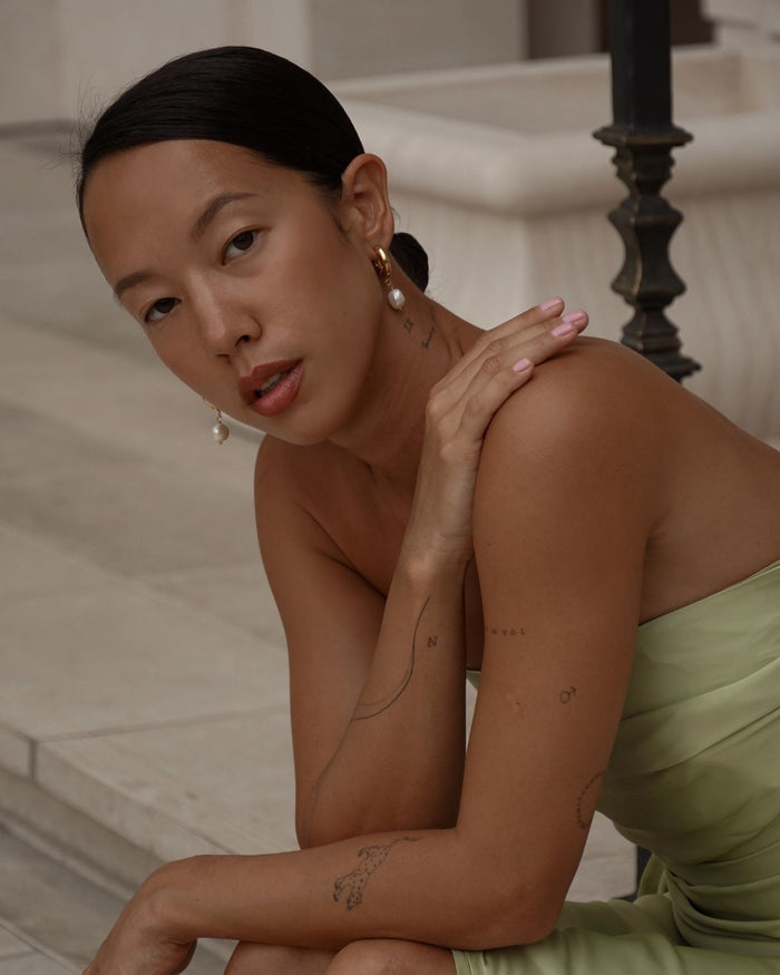 pearl earrings with removable charms on  a model