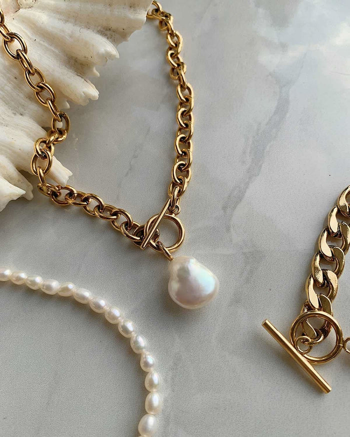 small and large pearls with gold chains