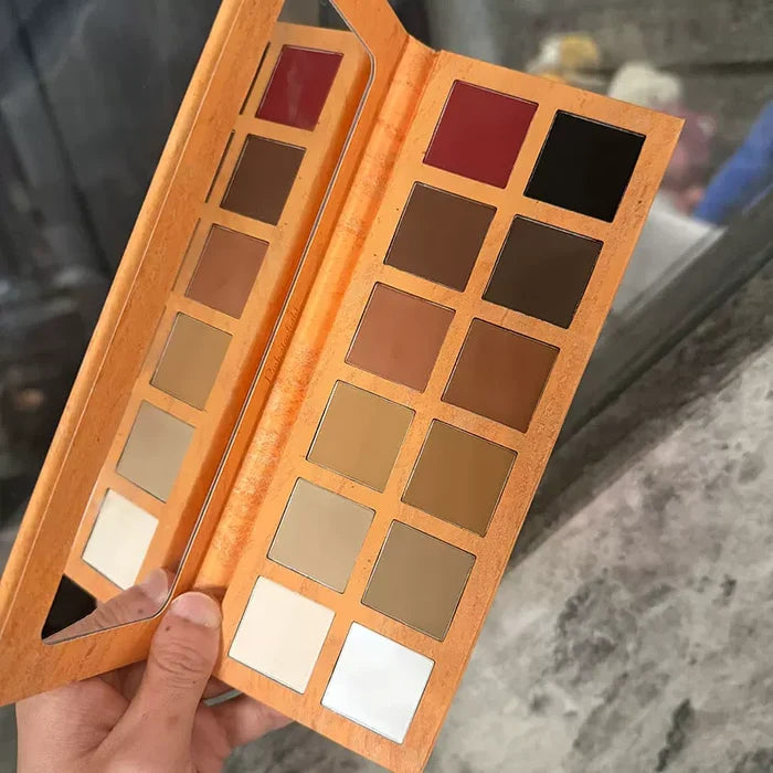 Open warm-toned eyeshadow palette with ten square pans and a mirror