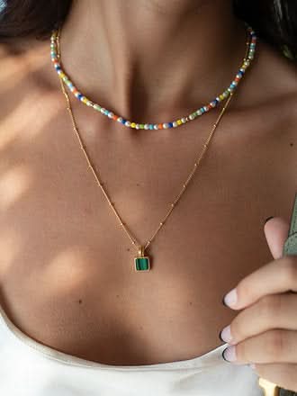 colorful necklace layered with a malachite necklace