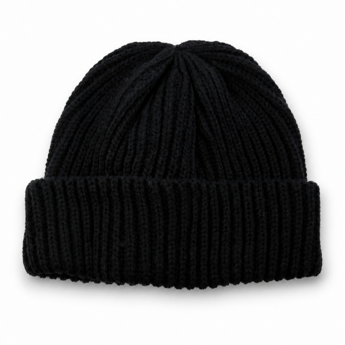 Black ribbed knit beanie with folded cuff on a white background with soft natural shadow.