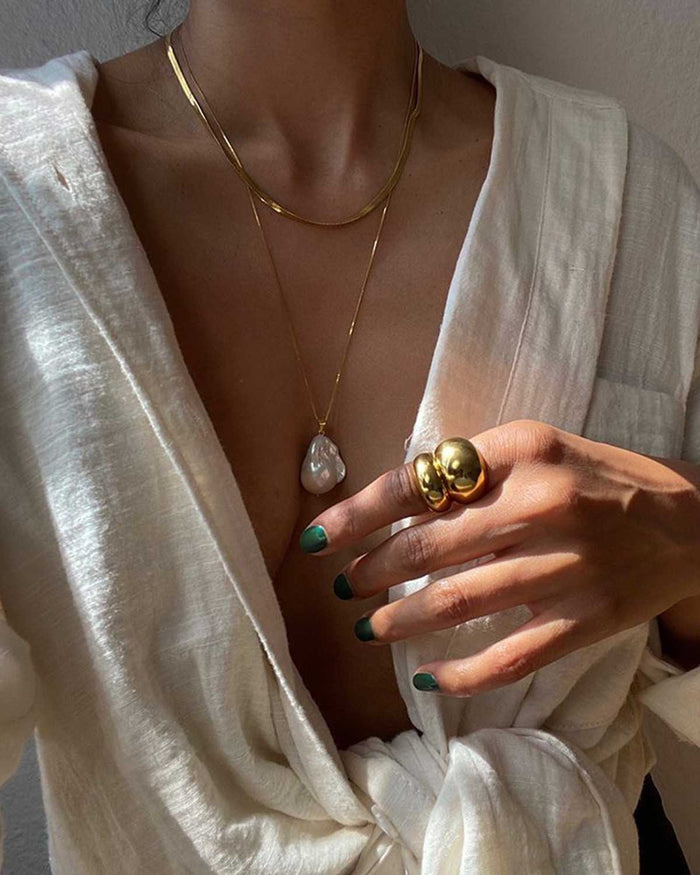 gold snake chain necklace layered with pearl pendant necklace