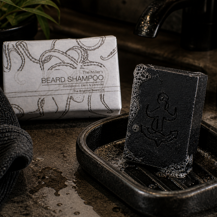 The Brighton Beard Co. The Miller’s Beard Shampoo Bar 100g in black soap dish with wrapped bar in rustic masculine bathroom setting