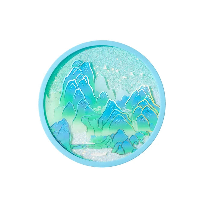 Round turquoise makeup compact with a blue-green mountain landscape design