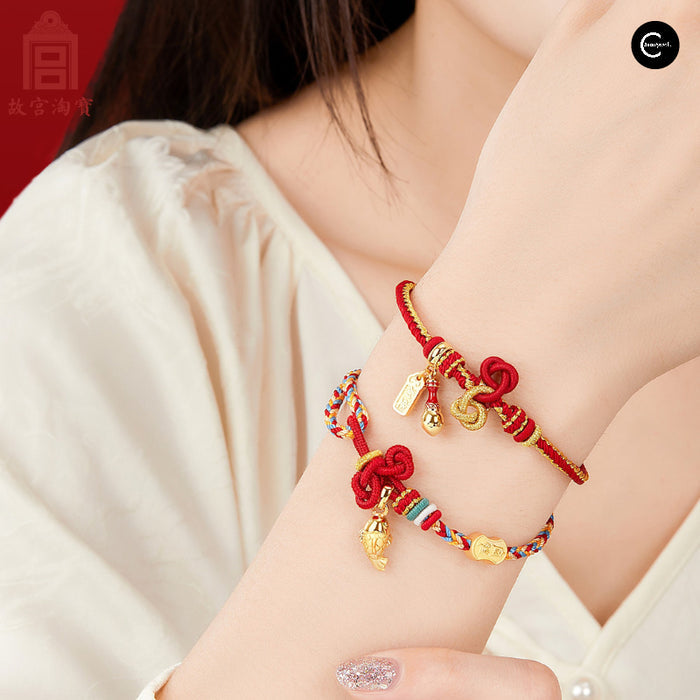 The Palace Museum red cord bracelets with gold-tone charms worn on a wrist