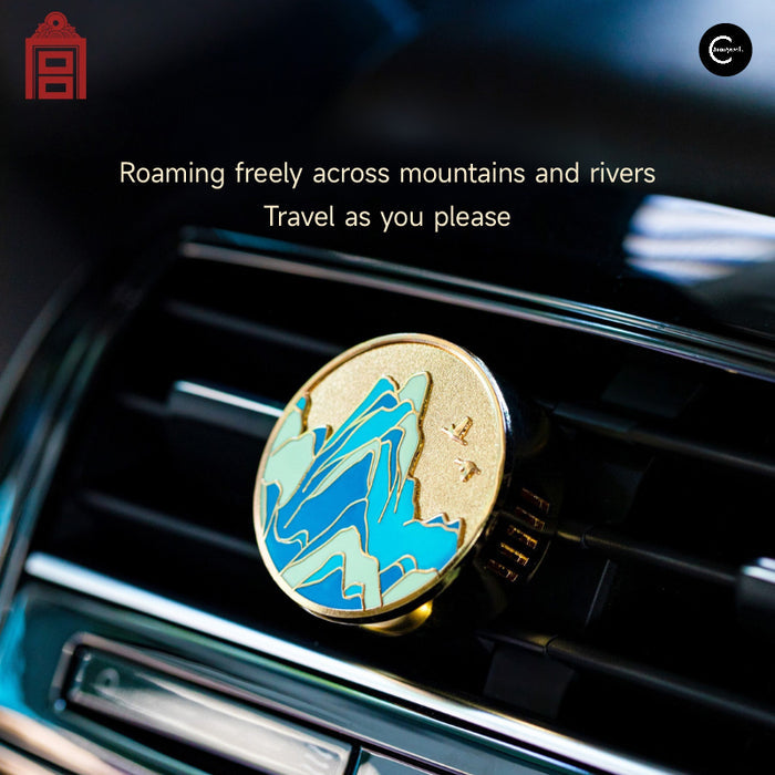The Palace Museum car fragrance with blue and green mountain design clipped to a car air vent