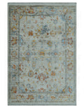 Oriental design area rug, light blue with rust and silver ornate motifs