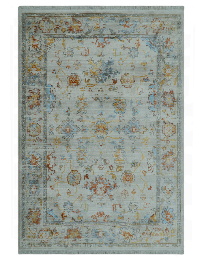 Oriental design area rug, light blue with rust and silver ornate motifs