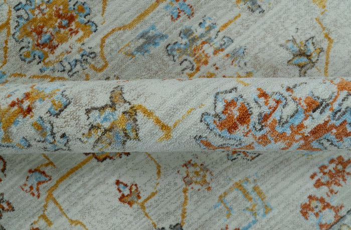 Oriental rug close-up with light blue pile and rust, silver, and blue pattern accents